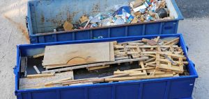 A photo of skips filled with construction and commercial waste